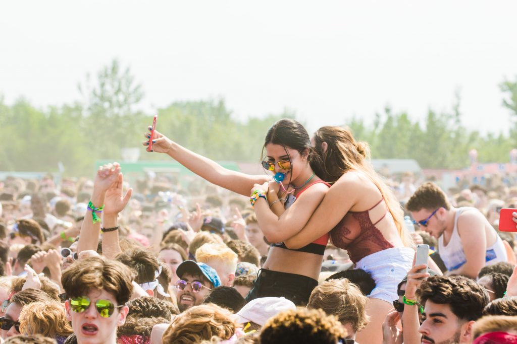 Armani Luminous Silk Glow Blush article - Two women embracing surrounded by crowd